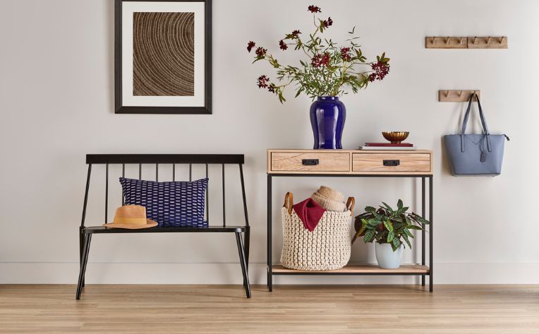 entryway with table and bench and hardwood floors